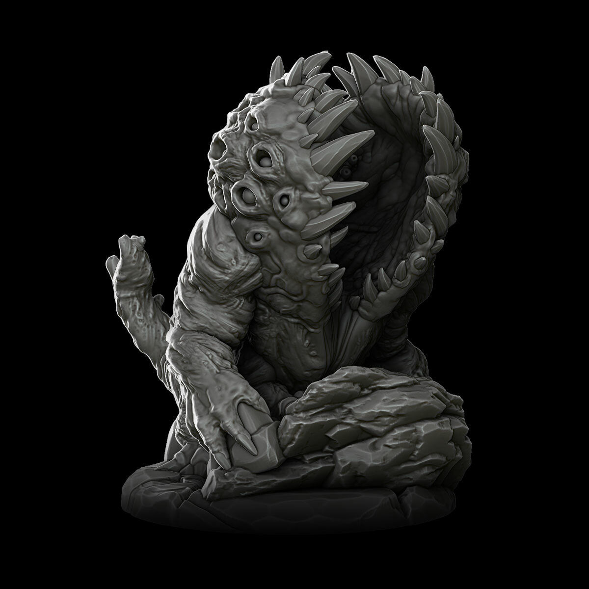 a statue of a demon sitting on a black background