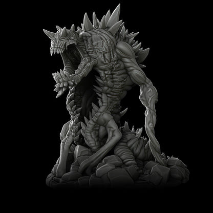 a black and white photo of a statue of a demon