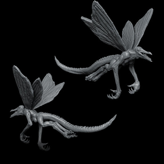 a couple of dragon figurines sitting next to each other