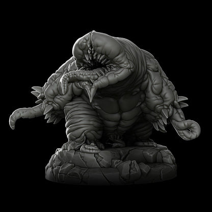 a statue of a monster on a black background