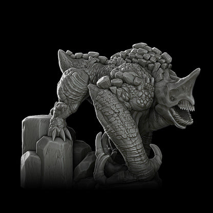 a black and white photo of a statue of a dinosaur