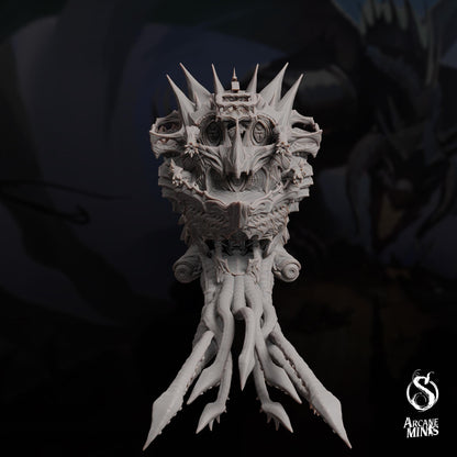 a statue of a demon with spikes on its head