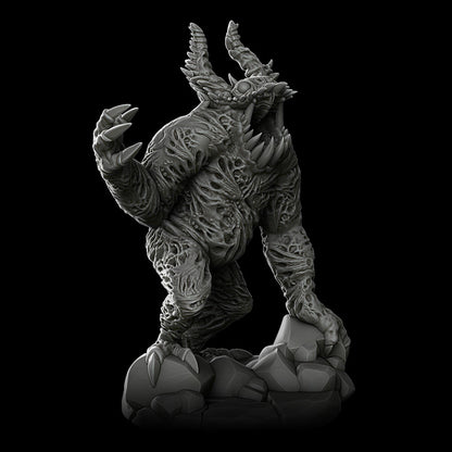 a black and white photo of a statue of a creature