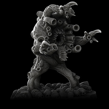 a black and white photo of a statue of a demon