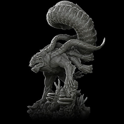 a black and white photo of a statue of a demon