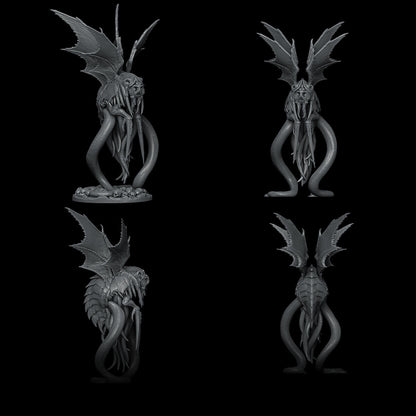 a black and white photo of a statue of a demon