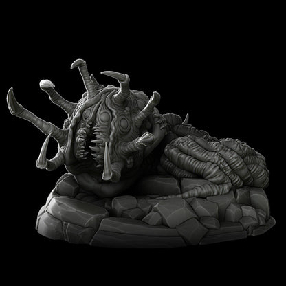 a strange creature laying on top of a pile of rocks