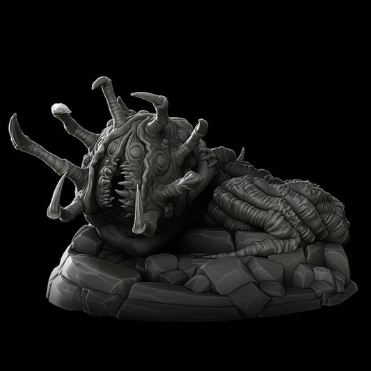 a strange creature laying on top of a pile of rocks