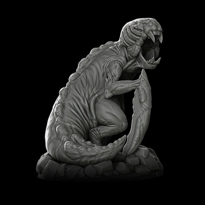 a statue of an alien sitting on top of a rock