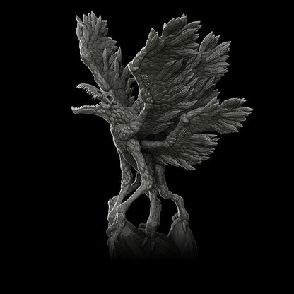 a black and white photo of a bird statue