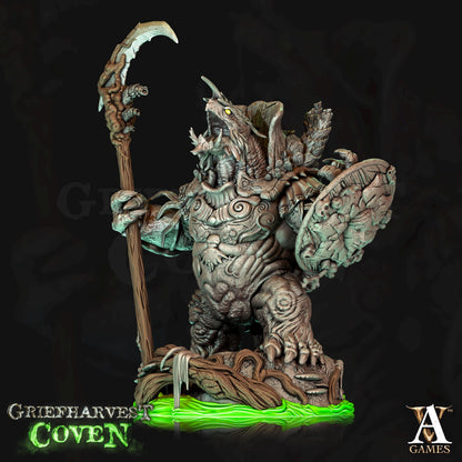 a statue of a creature holding a sceptacle