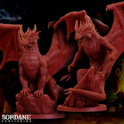 a couple of red dragon figurines sitting on top of a table