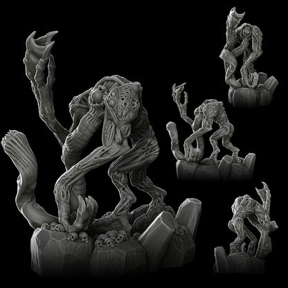 a group of alien figurines sitting on top of a rock