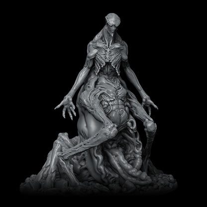 a statue of a woman sitting on top of a pile of rocks